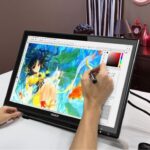 Graphics tablet with stylus used for precise digital drawing
